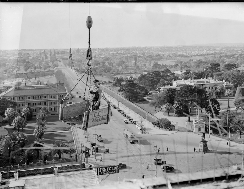 SRSA GRG35/342/1/311/box697/GN05612 Government House and North Adelaide. Man in a crane lift in the foreground. Picture by Frank Hurley